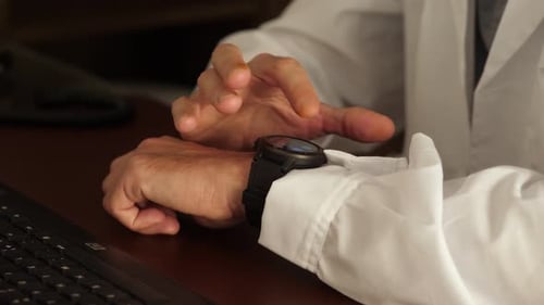 Young doctor Making Gestures On A Wearable Smart Watch, Smartwatch