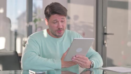 Man Having Video Call on Tablet Indoors