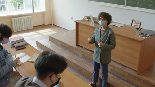 Teacher Giving Lecture to Students in Classroom