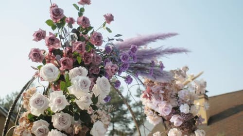 Medium Shot View of Wedding Floral Decorations of Flowers in Pastel Faded Colors Slow Motion Outside