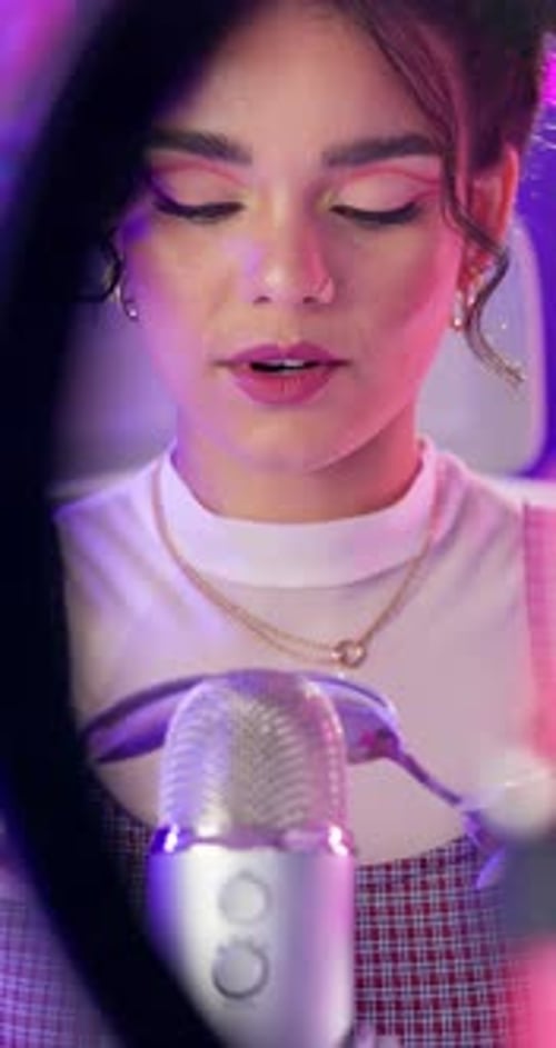 Microphone, spoons and woman on neon background for audio or sound therapy and podcast