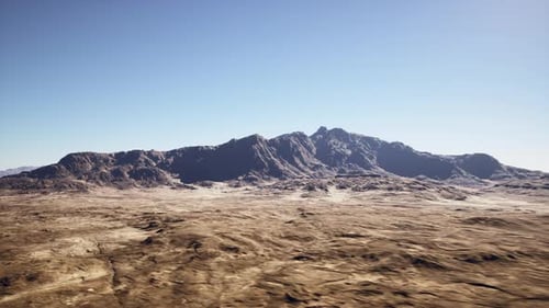Expansive Desert Scene with Rugged Ridges and Intense Midday Sunlight