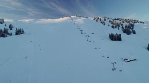 Ski Lift And Skiers On The Mountain Ski Resort In Saalbach-Hinterglemm, Austria - Aerial Drone Shot