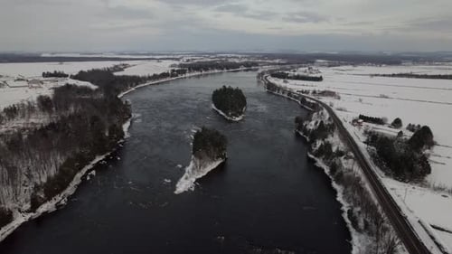 Frozen river in winter with two small islands