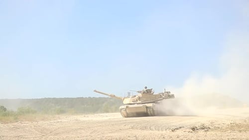 Powerful Army Tank Moving Through Desert Landscape