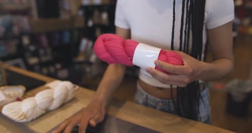 Close Up Female Business Owner Processing Inventory In Yarn Store