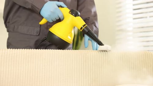 Steaming Cleaner Used on Couch by Person