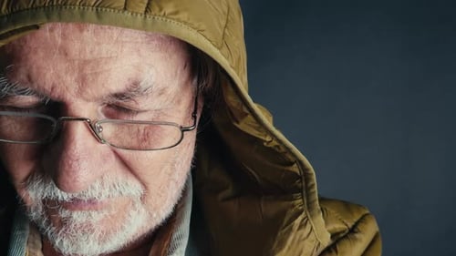 Senior Man with Glasses in Hooded Jacket