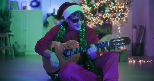 Man Plays Guitar at Christmas Time