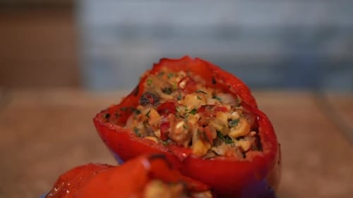 Close up of a tantalizing pair of stuffed red bell peppers ready to eat