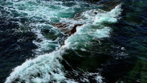 Powerful Waves Striking Isolated Rock in Clear Waters on North Sea Coast in Scotland Swells Crashing