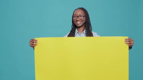 Portrait of Woman Holding Blank Cardboard Paper in Studio