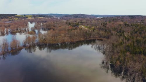 Aerial view flying over a flooded river that has overflowed after the spring melt