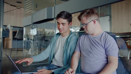 Young Men Working Together on a Laptop