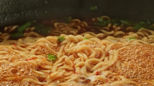 Close Up of Noodles Boiling in Broth