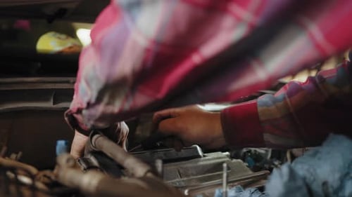 Professional Mechanic is Working on a Car in a Car Service Mechanic with Wrench