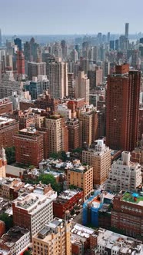 Diversity of New York architecture. Drone footage above the cityscape on bright sunny day.