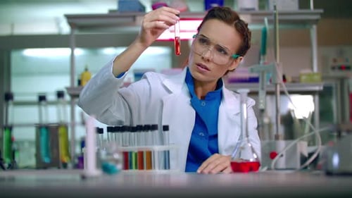 Woman scientist analyzing test tube in laboratory