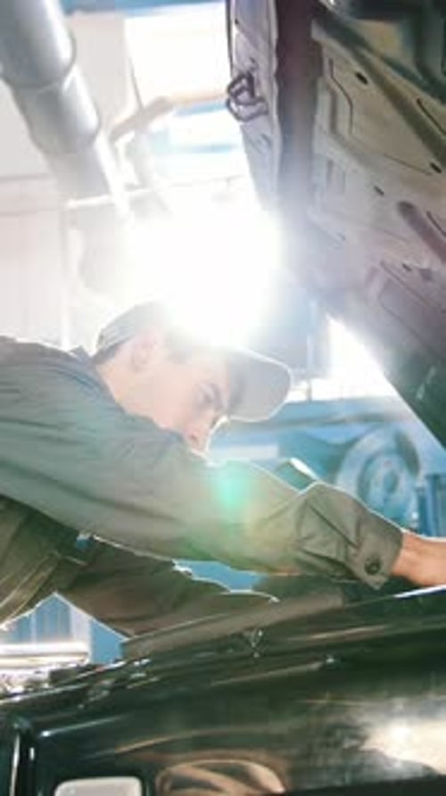 Mechanic Repairing a Car in Auto Repair Shop