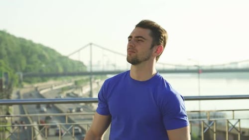 Young Man Stretching Outdoors in an Urban Setting