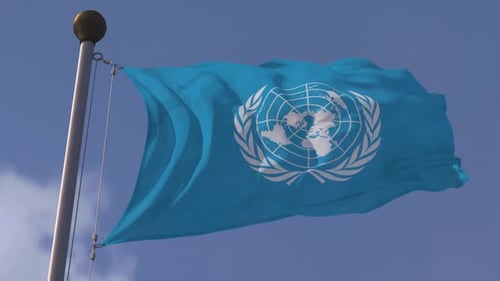 United Nations Flag Waving Against Blue Sky