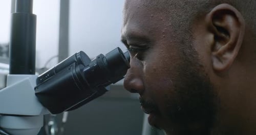Man Using Microscope in a Lab, Close Up