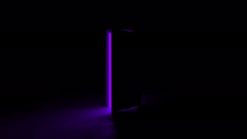 Mysterious purple light shining through opening door in dark room