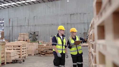 Male and female warehouse worker inspecting stock