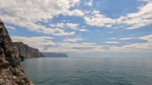 Sea Water Surface Aerial View on Calm Azure Sea and Volcanic Rocky Shores Small Waves on Water