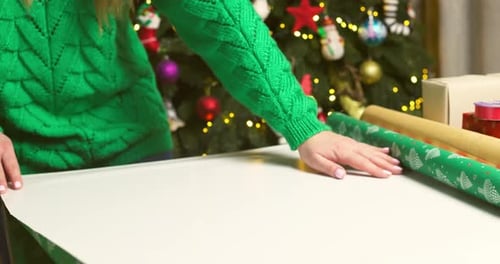 Woman Wrapping a Christmas Gift at Home