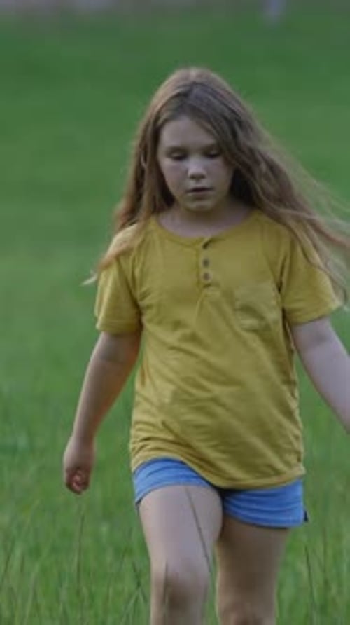 Young Girl Walking and Posing in a Field