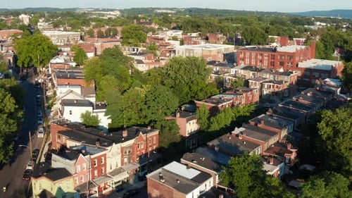 Residential city housing in summer golden hour American city in USA. Aerial reveal pullback shot.