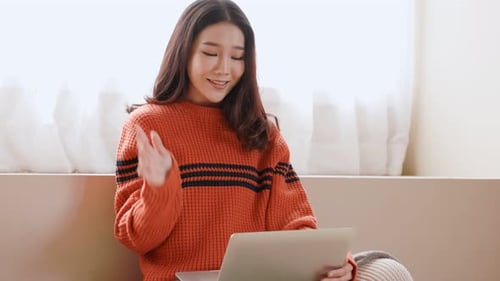 Young Woman Video Chatting and Waving Hello