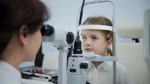 Optometrist Examining Child Eyes with Slit Lamp