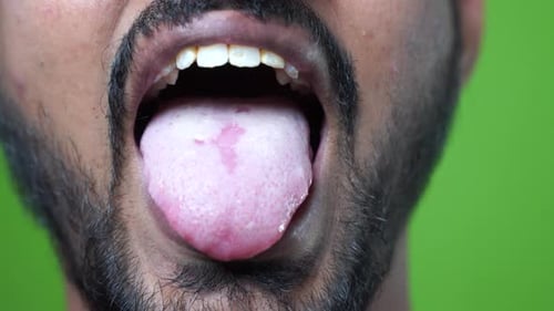 Young indian man with healthy teeth smiling on white background, closeup