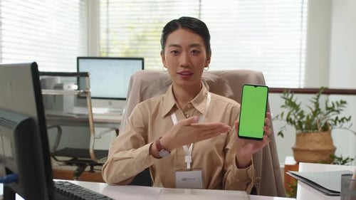 Woman Demonstrating App on Smartphone with Green Screen