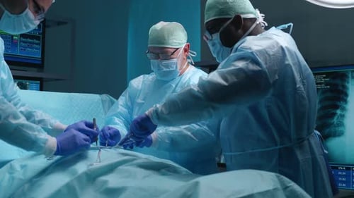 Team of Professional Medical Surgeons Performs the Surgical Operation in a Modern Hospital Doctors