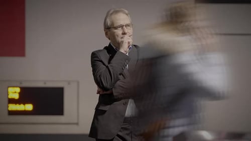 Man in Suit Pondering in Busy City