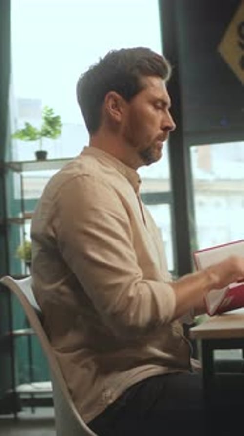 Handsome Man Working on Laptop in Modern Office
