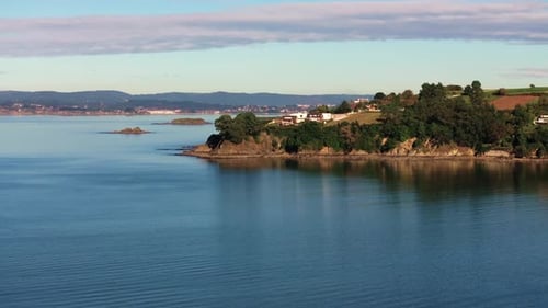 Headland With Vegetation In Coastal Town Of Mino In A Coruña, Spain. drone shot