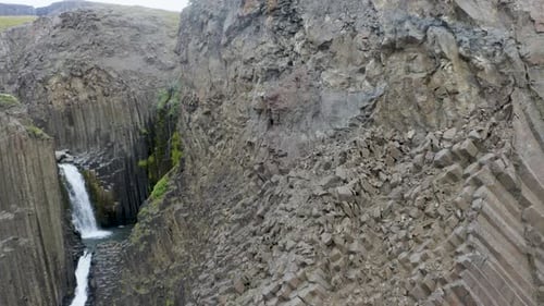 Straight Basalt Columns At Litlanesfoss Waterfall In Hengifossa in Fljotsdalur, Eastern Iceland. - a