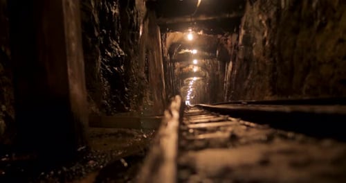 Low Angle View in Dimly Lit Mineshaft Tunnel