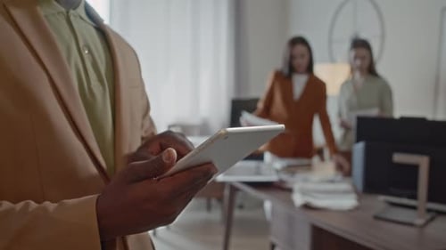 Office Manager Looking through His Digital Tablet