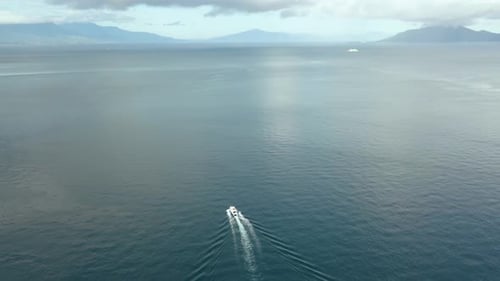 Boat Cruising Across the Deep Blue Ocean Water