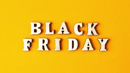 Zoom in Out Wooden Letters Text BLACK FRIDAY in Front Yellow Background Top View Flat Lay Seasonal