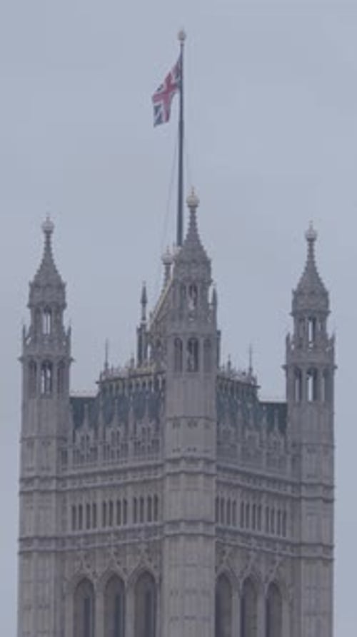 Houses of Parliament with Union Jack on Overcast Day