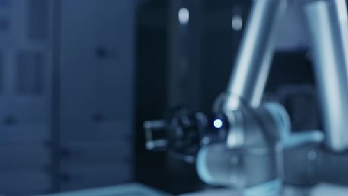 Robotic Arm Holding Computer Chip in High Tech Facility