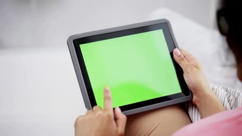 Woman Using Tablet With Chroma Key Screen