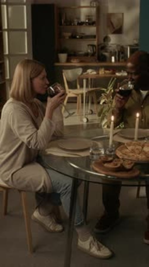 Couple Toasting with Wine at Romantic Dinner at Home