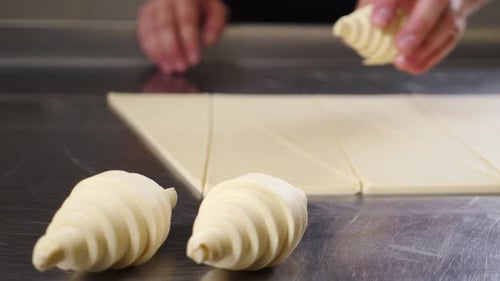 Baker preparing croissants in the kitchen